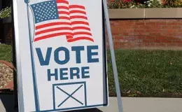 Sign that reads "Vote Here".