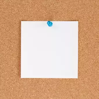 cork board with white paper pinned