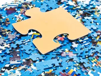 one big piece on pile of disassembled little blue jigsaw puzzles