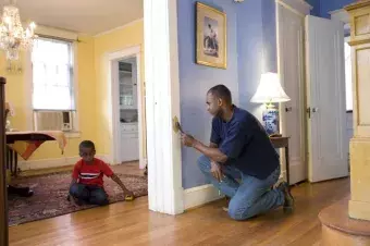 Parent painting while kid plays