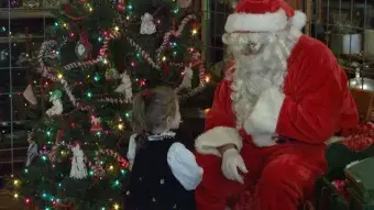 Little girl speaking to Santa.
