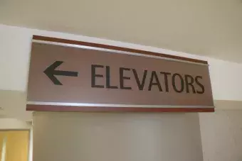 Sign with arrow to Elevators.