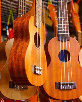 photo of ukuleles hanging from a ceiling