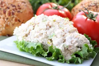 picture of chicken salad on a piece of lettuce, sitting on a plate