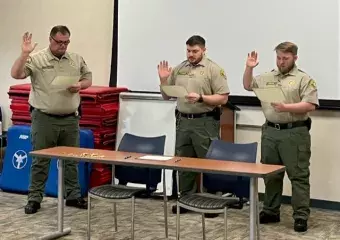 Two corrections officers being sworn in.