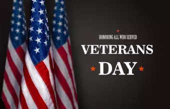 This says Honoring Those Who Served Veterans Day and has three American flags.