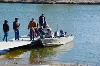 photo of people on a boat at the fishing dock