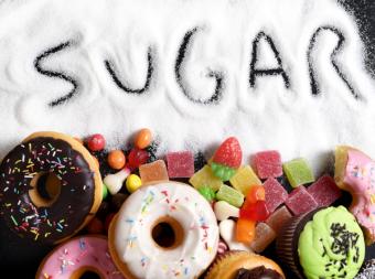 'Sugar' spelt in spilled sugar, images of donuts, and various sweets.