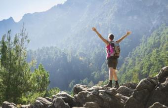 Woman in mountains "overcoming obstacles"