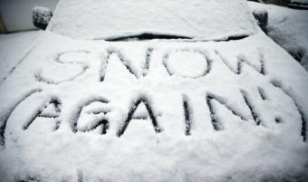 Words Snow again written in the snow