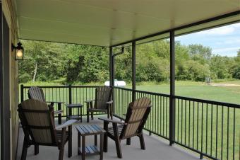 The covered patio featuring patio furniture for four people.