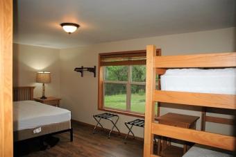 Bedroom with queen size bed and bunk bed.