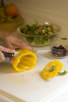 Cutting a yellow pepper.