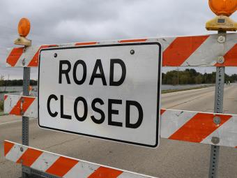 Street block with "Road Closed" sign.