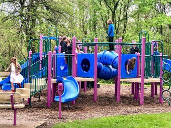 Children playing on the playground near the shelter.