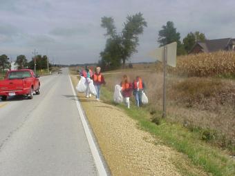 Volunteers cleaning up along roadside.
