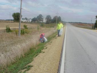 A few volunteers cleaning up along the roadway.