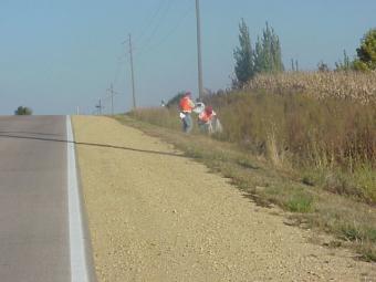 Adopt a Road cleanup volunteer in the ditch along the road.