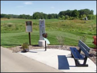 A golf station with information boards and benches.