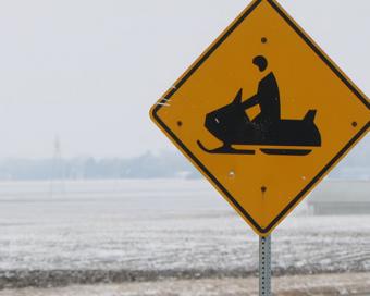 A roadside snowmobile sign.
