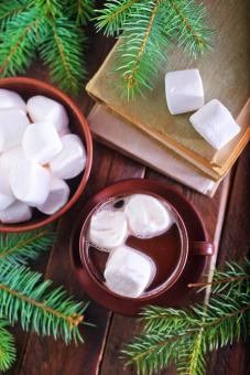 coffee with marshmallows in cup and on a table