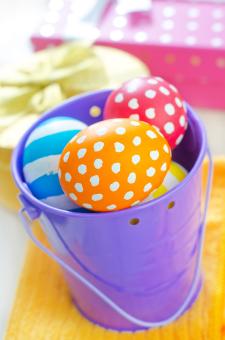 photo of Easter eggs in a small purple bucket