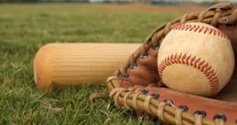 Image of baseball, glove and bat laying in grass