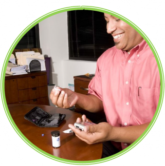 Image of man testing blood sugar at table