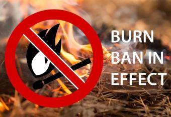grass on fire with a red circle and line over the fire to symbolize the ban.