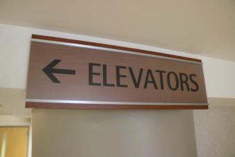 Sign with arrow to Elevators.