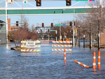 Road closed barricades flooded in water on River Drive.