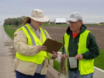 Volunteers reviewing water data on clipboard.