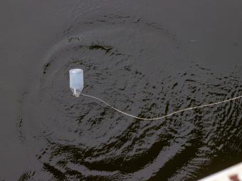 A water sampling jug dropped into the water.