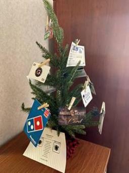Small Christmas tree with attached gift cards.