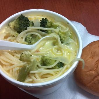 Soup in a bowl with a roll.