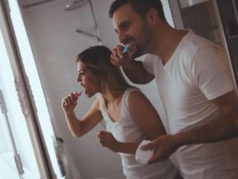 Man and woman brushing their teeth