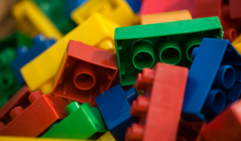 Pile of yellow, green, red, and blue toy building bricks.