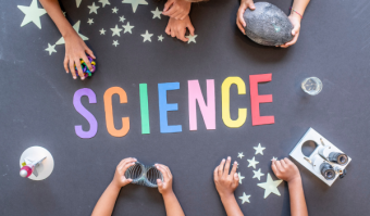 Photograph of children's hands playing with science objects around the word "science"