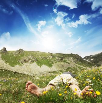 Photo of a Man Relaxing in the Mountains