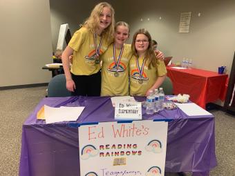 Photograph of 3 girls wearing medals