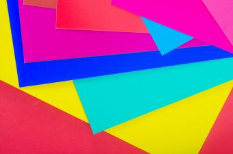 Pieces of paper in various colors, in a messy stack