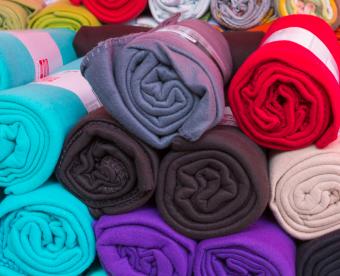 Many rolled colorful fleece blankets