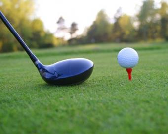 photo of a golf club and a ball on a tee