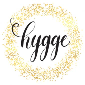 The word "hygge" surrounded by a gold, glittery circle. 
