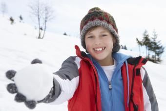 Pre-teen boy holding snowball