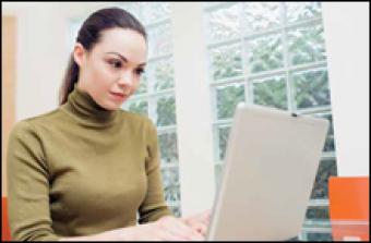 Woman using laptop computer to register for myuhc.com