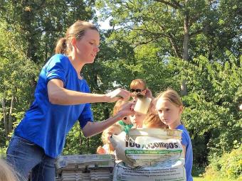 Female Wapsi Center naturalist educating children.