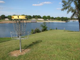 A disc basket with the lake in the background.