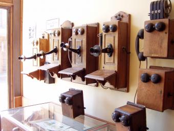 A bank of antique telephones.