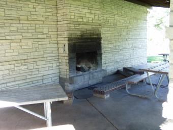 Closer view of the fireplace and bench seating at Sac-Fox Campground.